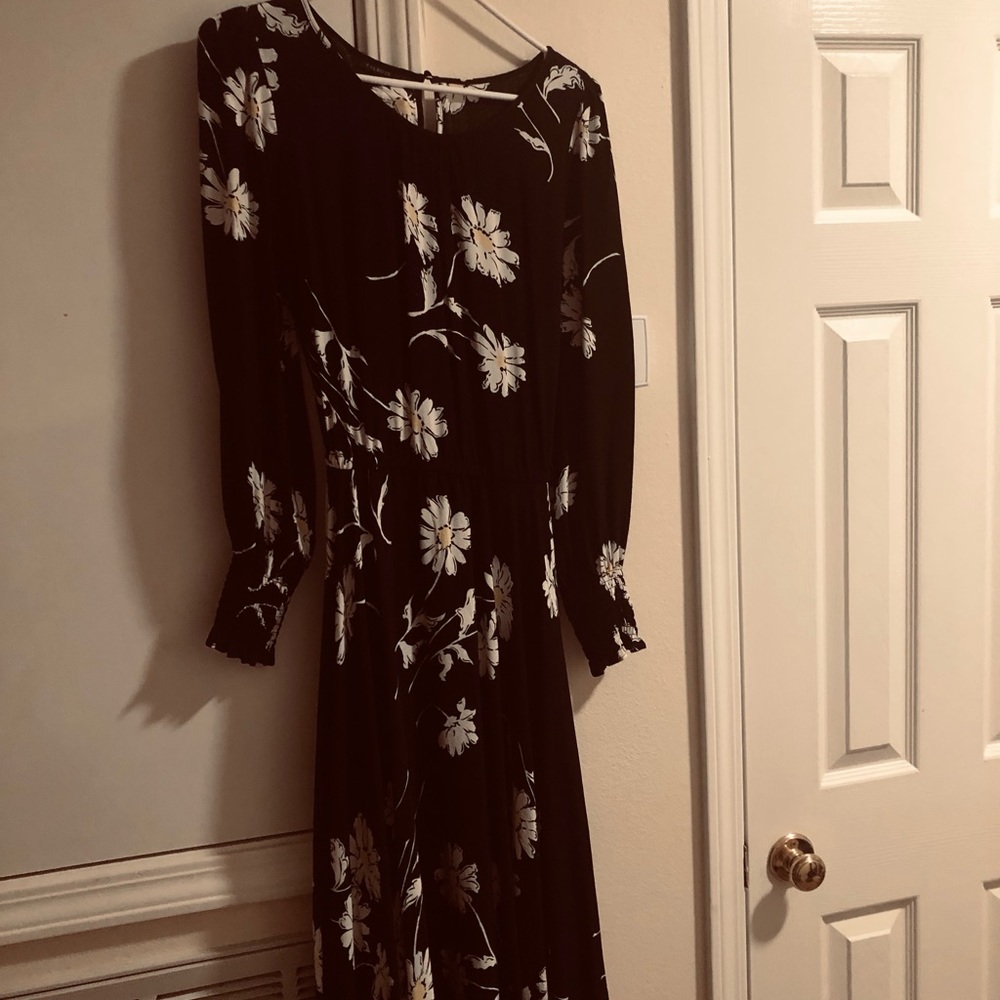 Black dress with daisies.  It is mid calf.
